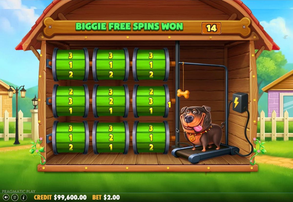 Before free spins: nine green barrels in the kennel, each with 1, 2 and 3 printed on it, the Rottweiler on a treadmill on the right and the counter Biggie free spins won 14.